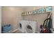 Laundry room with a washer, dryer, and shelving for storage space at 3277 E Meadowview Dr, Gilbert, AZ 85298
