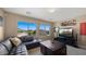 Living room showcasing leather sectional, dark wood accents, and a view of the community and mountains at 3277 E Meadowview Dr, Gilbert, AZ 85298