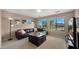 Living room with leather sectional couch, golf course view, large windows, and neutral colors at 3277 E Meadowview Dr, Gilbert, AZ 85298