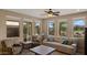 Bright living room featuring multiple windows offering views of lush greenery and comfortable seating at 3277 E Meadowview Dr, Gilbert, AZ 85298