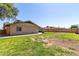 Spacious backyard with mature trees, large grass area, and block fence at 3536 W Cholla St, Phoenix, AZ 85029
