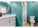 Bathroom with stylish vanity, framed round mirror, glass-enclosed shower, and tiled floors at 3536 W Cholla St, Phoenix, AZ 85029