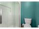 Bathroom features a white tiled shower with glass door and low flow toilet at 3536 W Cholla St, Phoenix, AZ 85029