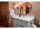 Updated bathroom features a modern vanity, framed round mirror, and stylish fixtures at 3536 W Cholla St, Phoenix, AZ 85029