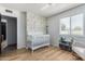Light-filled Bedroom featuring a white crib, changing table, and playful wallpaper at 3536 W Cholla St, Phoenix, AZ 85029