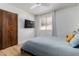 Bedroom features hardwood floors, natural light, a TV and closet at 3536 W Cholla St, Phoenix, AZ 85029