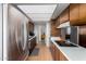 Bright kitchen with stainless steel refrigerator and wood cabinets offering ample storage space at 3536 W Cholla St, Phoenix, AZ 85029