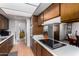 Well-lit kitchen with wood cabinetry, laminate countertops, and modern appliances providing a functional cooking area at 3536 W Cholla St, Phoenix, AZ 85029