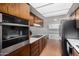 Modern kitchen with stainless steel appliances, ample cabinet space, and sleek countertops at 3536 W Cholla St, Phoenix, AZ 85029