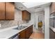 Classic kitchen featuring wood cabinets, laminate countertops and modern faucet fixtures at 3536 W Cholla St, Phoenix, AZ 85029