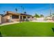 Spacious backyard with artificial turf, covered patio, and sparkling private pool at 3901 W Augusta Ave, Phoenix, AZ 85051