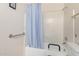 Well-lit bathroom with a shower-tub combo featuring a light blue shower curtain and safety bars at 3901 W Augusta Ave, Phoenix, AZ 85051