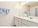 Bathroom featuring a dual sink vanity with white cabinets and a large mirror at 3901 W Augusta Ave, Phoenix, AZ 85051