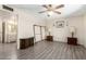 An airy bedroom with wood-look floors, a ceiling fan, and neutral paint at 3901 W Augusta Ave, Phoenix, AZ 85051