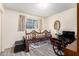 Bedroom with wood-look floors and window with curtains, and a wheelchair in front of the bed at 3901 W Augusta Ave, Phoenix, AZ 85051
