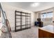 A bedroom with carpet, a desk and a large bookshelf at 3901 W Augusta Ave, Phoenix, AZ 85051