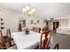 Open concept dining room with chandelier and view into the living room at 3901 W Augusta Ave, Phoenix, AZ 85051