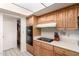 A traditional kitchen featuring oak cabinets, a cooktop, and a built-in oven at 3901 W Augusta Ave, Phoenix, AZ 85051
