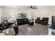 Bright living room with neutral walls, ceiling fan and black leather sofas at 3901 W Augusta Ave, Phoenix, AZ 85051