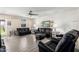 Living room with wood paneling, ceiling fan and two black leather sofas at 3901 W Augusta Ave, Phoenix, AZ 85051