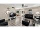 Open living room with black leather sofas and a view to dining area at 3901 W Augusta Ave, Phoenix, AZ 85051