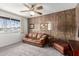 Cozy living room with wood paneling, soft carpet, and a comfortable leather sofa at 3901 W Augusta Ave, Phoenix, AZ 85051