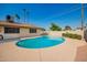 Private backyard pool surrounded by lush landscaping and ample patio space at 3901 W Augusta Ave, Phoenix, AZ 85051
