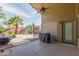Inviting back patio with ceiling fan, barbecue grill, and view of the sparkling pool at 42277 W Chisholm Dr, Maricopa, AZ 85138