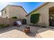Private backyard featuring brick pavers, mature landscaping, and secure block fencing at 42277 W Chisholm Dr, Maricopa, AZ 85138