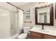 Well-lit bathroom featuring framed mirror, shower and modern fixtures at 42277 W Chisholm Dr, Maricopa, AZ 85138