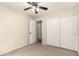 Bedroom featuring neutral walls, ceiling fan and large closet at 42277 W Chisholm Dr, Maricopa, AZ 85138