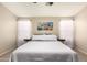 Inviting bedroom with neutral tones, soft lighting, and a calming atmosphere at 42277 W Chisholm Dr, Maricopa, AZ 85138