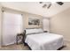 Calm bedroom with a white comforter, soft natural lighting, and neutral tones at 42277 W Chisholm Dr, Maricopa, AZ 85138
