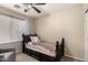 Cozy bedroom featuring neutral walls, ceiling fan and natural light at 42277 W Chisholm Dr, Maricopa, AZ 85138