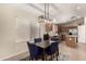 Cozy dining area with a modern light fixture and comfortable blue chairs at 42277 W Chisholm Dr, Maricopa, AZ 85138