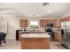 Bright kitchen with stainless steel appliances and a central island at 42277 W Chisholm Dr, Maricopa, AZ 85138