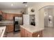 Spacious kitchen featuring stainless steel appliances and tile countertops at 42277 W Chisholm Dr, Maricopa, AZ 85138