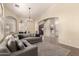 Spacious living room with vaulted ceilings, plush seating, and an open floor plan at 42277 W Chisholm Dr, Maricopa, AZ 85138
