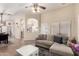 Inviting living room featuring a plush sofa and neutral tones at 42277 W Chisholm Dr, Maricopa, AZ 85138