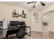 Office area featuring neutral walls, tile flooring, built-in shelving and natural light at 42277 W Chisholm Dr, Maricopa, AZ 85138
