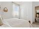 Bright bedroom with white walls, a comfortable bed, and natural light from the window at 46422 W Lander Ln, Maricopa, AZ 85139