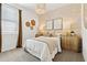 Beautiful bedroom with a large window, stylish light fixture, and elegant decor at 46422 W Lander Ln, Maricopa, AZ 85139