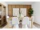 This dining room features decorative wall panels, modern decor and stylish furnishings at 46422 W Lander Ln, Maricopa, AZ 85139