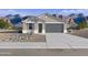 Charming single-story home featuring a gray exterior, a two-car garage, and desert landscaping at 46422 W Lander Ln, Maricopa, AZ 85139