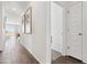 Hallway with wood-look tile flooring, white walls, and access to different areas of the home at 46422 W Lander Ln, Maricopa, AZ 85139