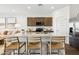Kitchen featuring a large island with bar seating, stainless steel appliances, and modern finishes at 46422 W Lander Ln, Maricopa, AZ 85139