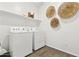 Modern laundry room equipped with white appliances and stylish wall decor for a fresh look at 46422 W Lander Ln, Maricopa, AZ 85139