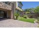 View of a backyard with green lawn and a patio with paver stones at 4700 S Fulton Ranch Blvd # 62, Chandler, AZ 85248