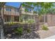 Rear view of the home across the fenced in lawn with mature landscaping at 4700 S Fulton Ranch Blvd # 62, Chandler, AZ 85248
