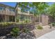 Rear view of the home across the fenced in lawn with mature landscaping at 4700 S Fulton Ranch Blvd # 62, Chandler, AZ 85248